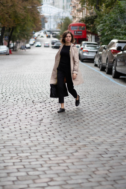 Selbstbewusste junge Frau im schicken Outfit überquert die Straße. Schuss in voller Länge - Foto, Bild
