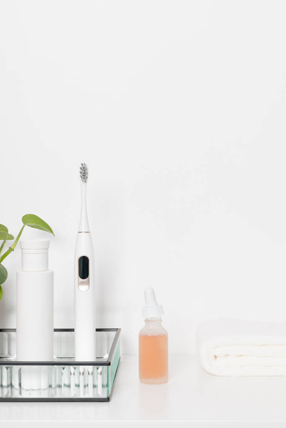 Beauty health care composition with towel, tonic and serum on a white table.  - Photo, Image