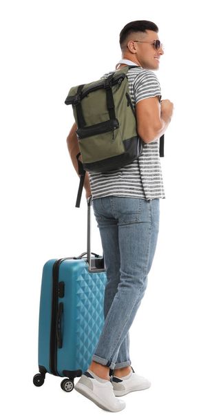 Man with backpack and suitcase on white background, back view. Summer travel - Fotó, kép