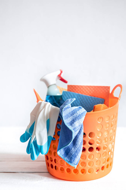 Close up set of home cleaning products in a bright basket. Means for maintaining cleanliness. - Photo, Image