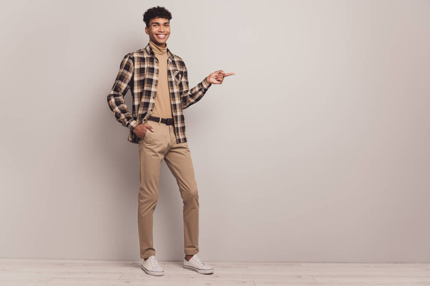 Photo of guy direct finger empty space wear checkered shirt pants footwear isolated grey color background - Valokuva, kuva