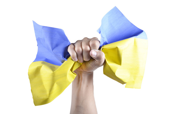 hand grijpt de Oekraïense vlag - Foto, afbeelding