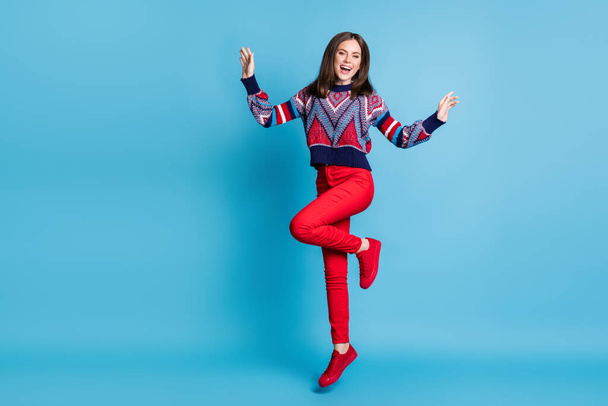 Full length body size view of attractive cheerful girl wear cozy clothes jumping having fun isolated over bright blue color background - Fotoğraf, Görsel