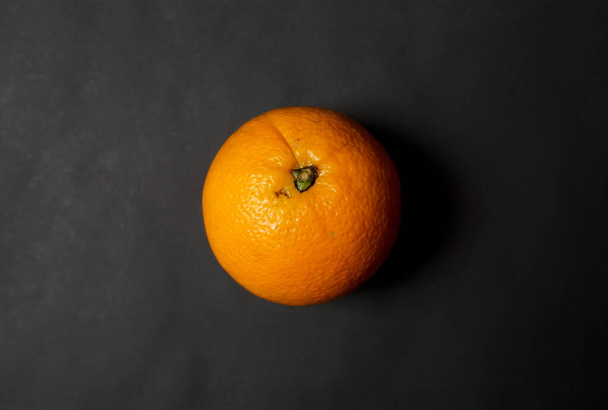 Fresh orange on black background. - Zdjęcie, obraz