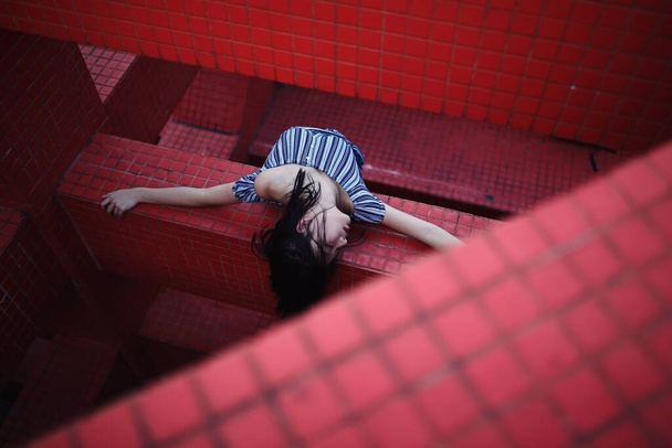 young woman sitting on floor and looking at camera - Valokuva, kuva