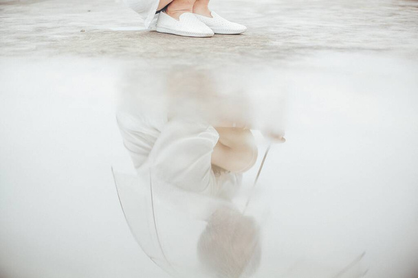 ballerina in white tutu and pointe shoes on a light background - 写真・画像