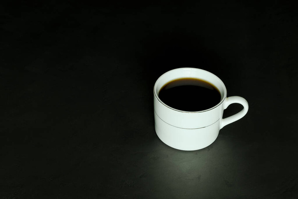 White cup with black coffee on black background - Φωτογραφία, εικόνα