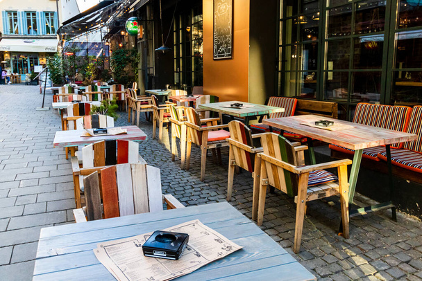 Close up of an empty tables with empty chairs at a local outdoor resturant in Bucharest, Romania, 2021 - Photo, image