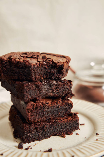 A vertical shot of deliciously prepared Brownies on a table - Фото, изображение