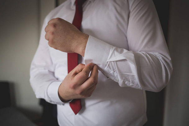 A closeup shot of a man wearing a white shirt with a red tie - Φωτογραφία, εικόνα