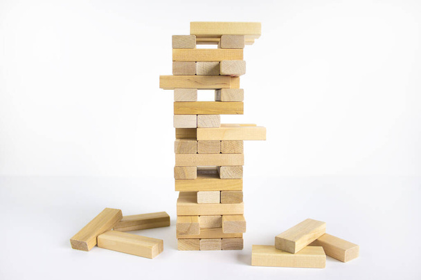 Wood block tower with architecture model. Concept Risk of management and strategy plan, growth business success process and team work. Beautiful white background, copy space. - Фото, изображение