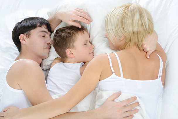 Happy family lying in bed - Φωτογραφία, εικόνα