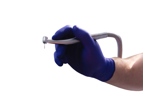 Drill in hand at the dentist on white background - Φωτογραφία, εικόνα