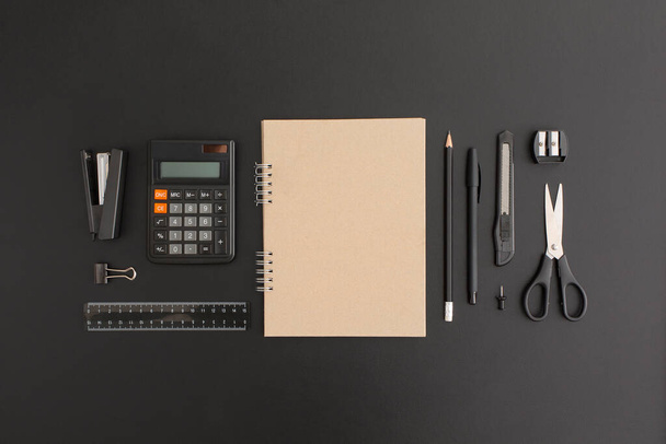 Office and school stationery on black leather background - Foto, Imagem