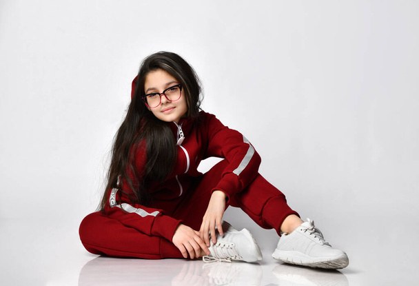 Trendy caucasian preteen girl model in fashion eyeglasses and tracksuit - Photo, Image