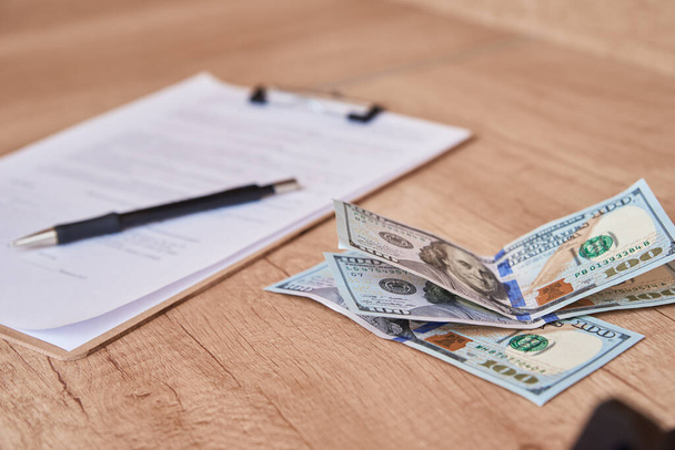 Document, pen and dollar bills on the table, close up - Φωτογραφία, εικόνα