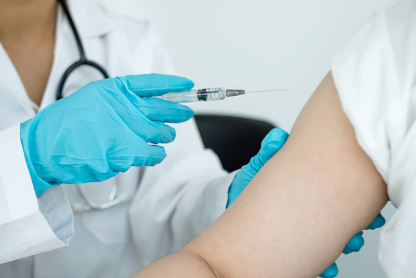 Female doctors vaccinated with syringes to prevent epidemics at hospitals, health care, and medical concepts. - Photo, Image