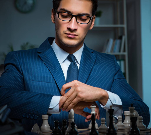 Businessman playing chess in strategy concept - Foto, Imagem