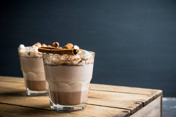 Hot Chocolate drink with marshmallow and cinnamon in old-fashioned glass. Selective focus. - Foto, Imagem