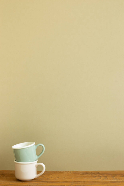 Stack of mug cup on wooden table. khaki beige background - Valokuva, kuva