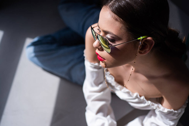 Fashion sunglasses. Young woman in glasses. Sensual model girl posing. - 写真・画像