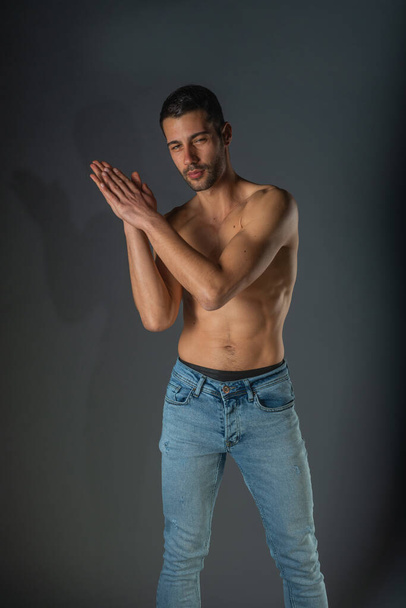 Studio portrait of a shirtless sexy man with abs in denim blue jeans - Fotografie, Obrázek