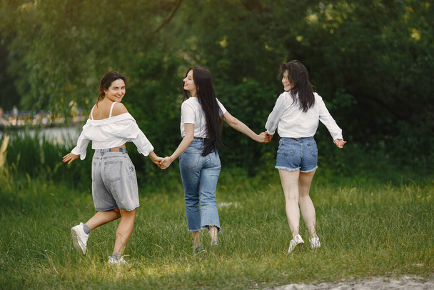 Girls spend time in a summer park - Фото, изображение