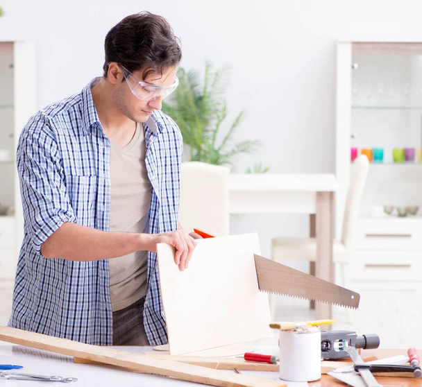 Young man in woodworking hobby concept - Photo, Image