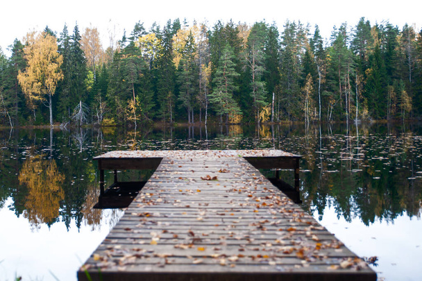 Lege pier van een prachtig meer, herfststemming. Sfeervolle panoramische foto. Het concept van de schoonheid van de natuur, vrede, eenzaamheid - Foto, afbeelding