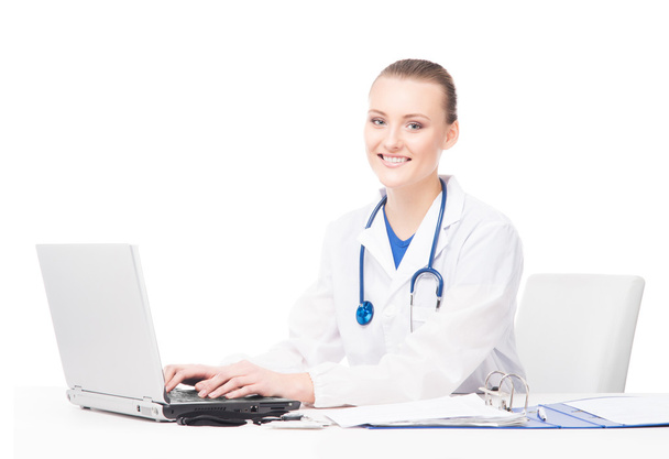 female doctor working in office on laptop - Fotó, kép