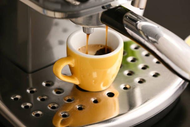 Modern coffee machine with cup of hot espresso in cafe - Photo, Image