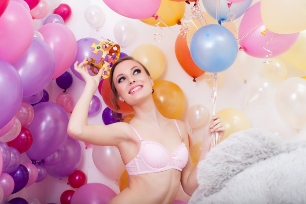 Image of happy young woman tries on toy crown - Fotoğraf, Görsel