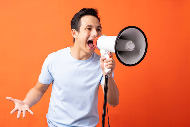Asian man holding megaphone and shouting - Photo, Image