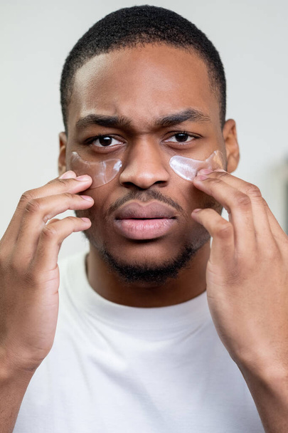 male facial care skin irritation man eye patches - Foto, afbeelding