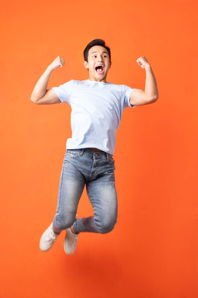 Asian man jumping and shouting - Fotoğraf, Görsel