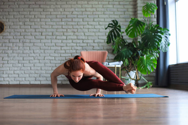 Healthy life. Attractive woman practicing home yoga, working out, wearing sportswear - 写真・画像