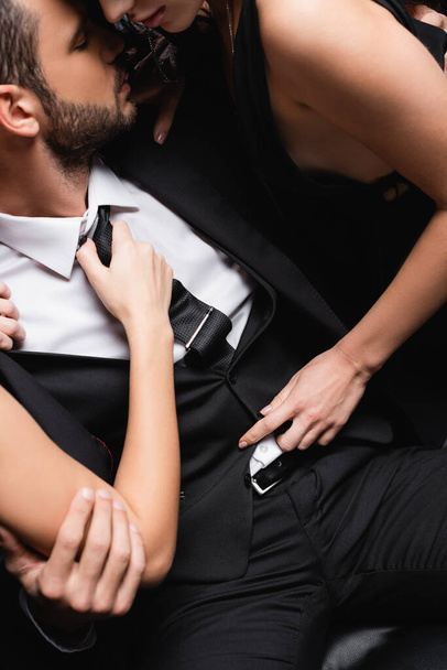 high angle view of passionate women undressing young businessman in suit - Photo, Image