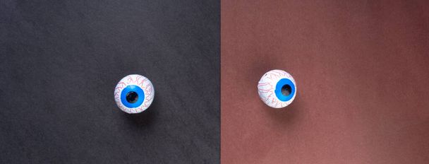 ハロウィーンのキャンディーの目玉の背景、コピースペース。グリーティングカードで甘いハロウィンチョコレート怖い目 - 写真・画像