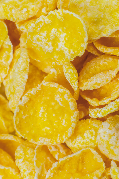 Yellow Cornflakes close up photo, Food texture background, top view. Macro shot. Perfect breakfast. - Foto, immagini