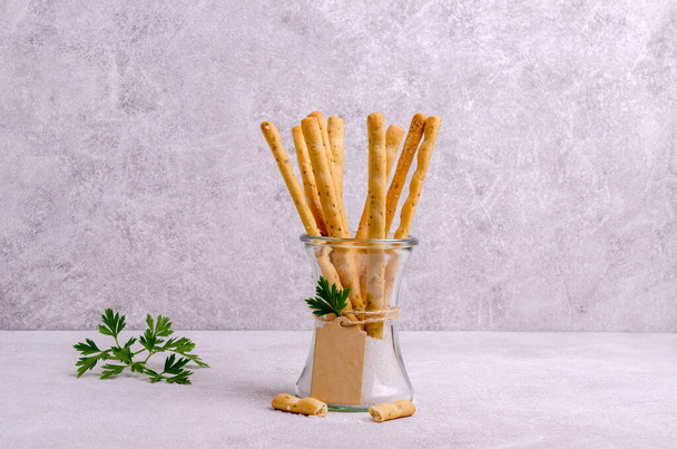 Traditional breadsticks with salt and parsley. Selective focus. - Photo, Image