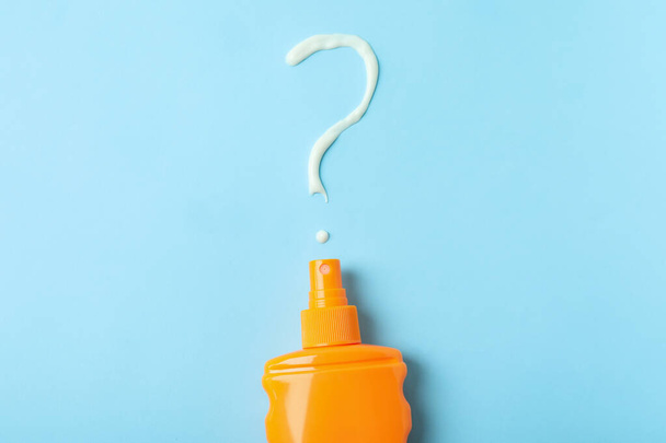 Sunscreen with question mark on blue background - Photo, Image