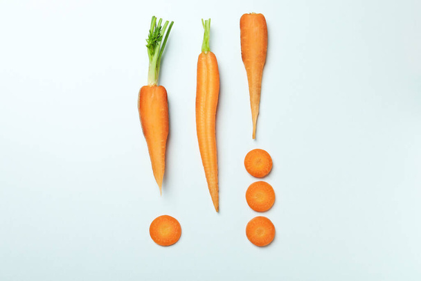Flat lay with carrot slices on white background - Фото, зображення