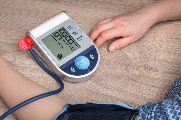 Blood pressure monitor with high pressure level on screen - hypertension concept - Photo, Image