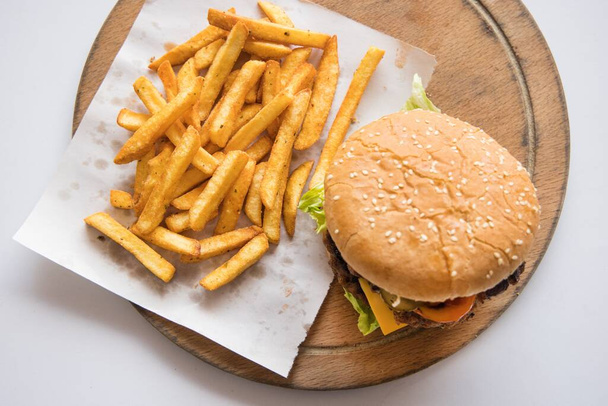 A sandwich and fries on a plate - Фото, зображення