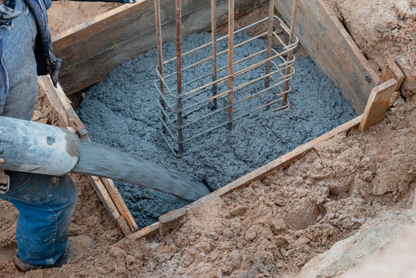 pouring concrete from a concrete mixer on a single-family house construction site - Photo, Image