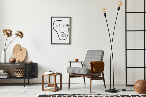 Stylish scandinavian composition of living room with design armchair, black mock up poster frame, commode, wooden stool, lamp, decoration, loft wall and personal accessories in modern home decor. - Foto, imagen