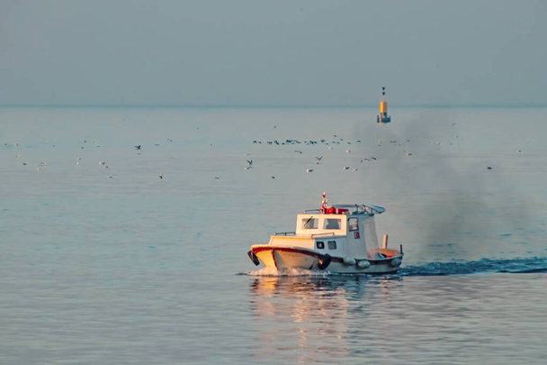 sunrise and fisherboats on marmara sea in istanbul - Vector, Image