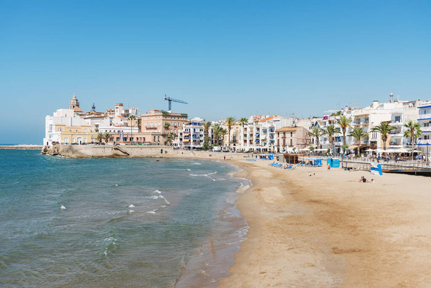 Sitges, a city in Spain at the Mediterranean Sea, a world-famous resort. Beach vacation. Long sand beach - Zdjęcie, obraz