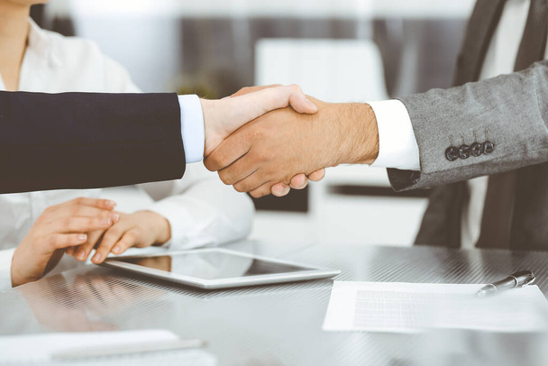 Handshake as successful negotiation ending, close-up. Unknown business people shaking hands after contract signing in modern office - Foto, immagini