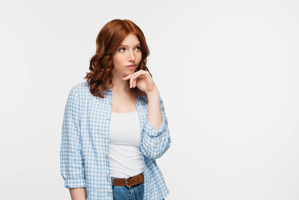 pensive redhead woman in plaid shirt isolated on white  - Fotó, kép
